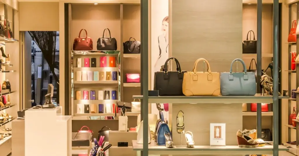 Chic boutique with a variety of handbags and shoes elegantly displayed on shelves.