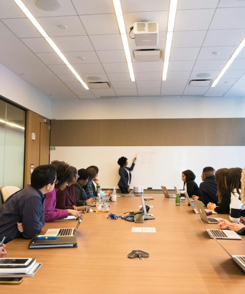 Business meeting with diverse team discussing projects in a modern conference room.