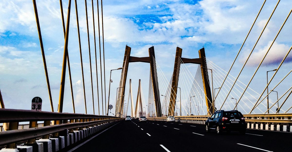 Vibrant view of a modern cable-stayed bridge in Mumbai under a clear blue sky.